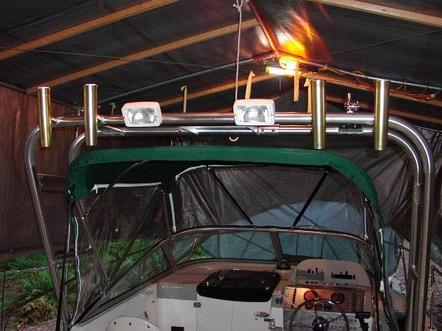Atlantic Towers arch installed on a 2302 Trophy boat with mounted lights and rod holders under a covered shelter