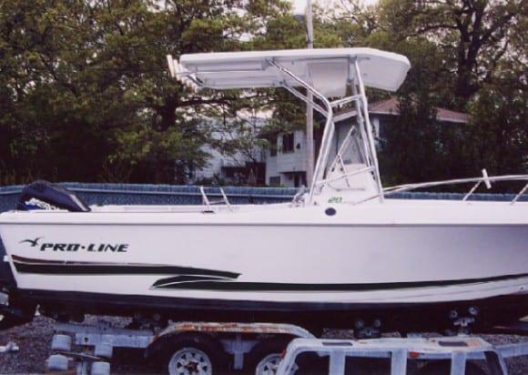 Pro Line Center Console boat on trailer with installed Atlantic Towers T-Top roof and metal frame in wooded area.