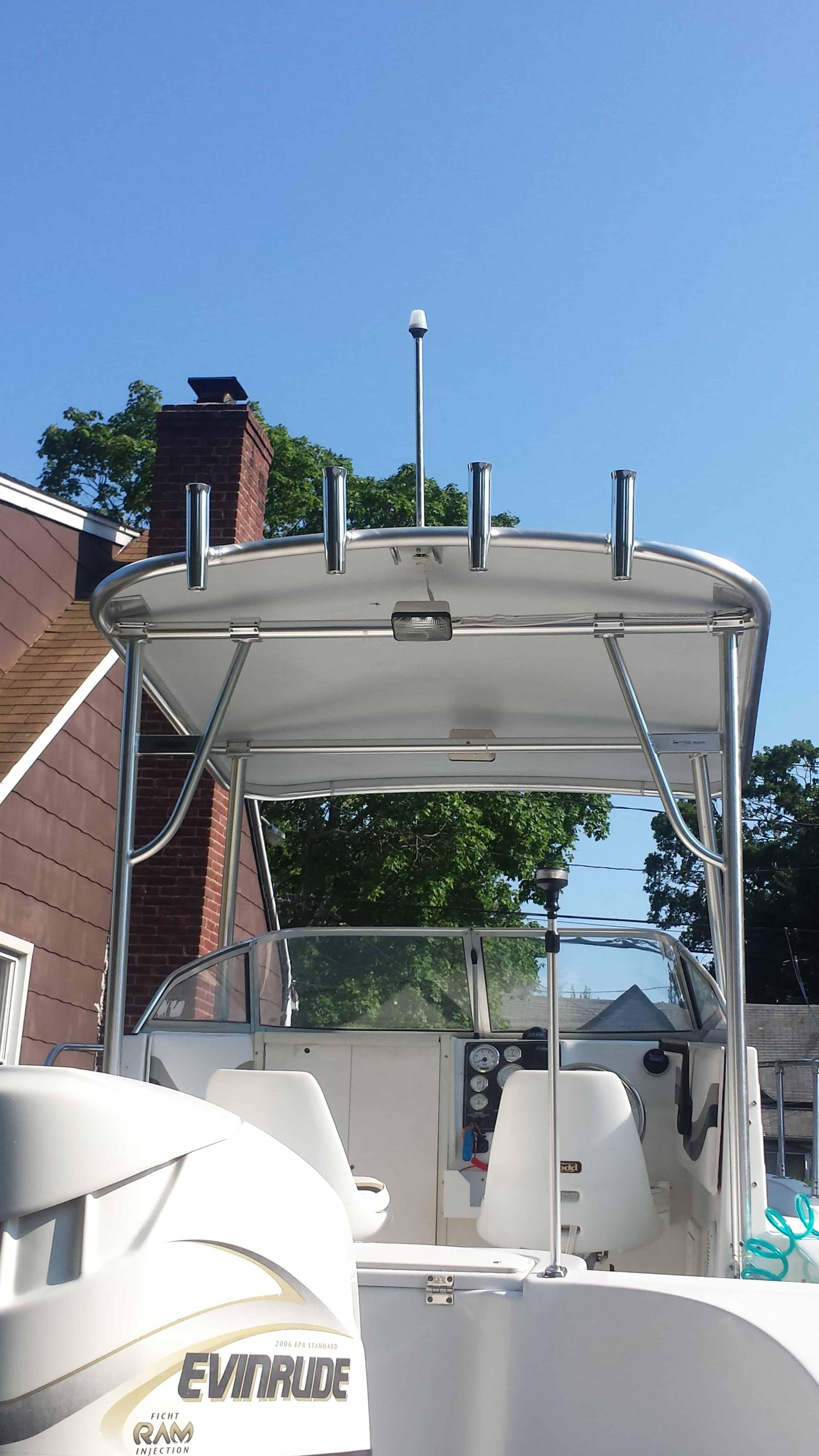 Atlantic Towers Arch installed on a boat, featuring a view of the cockpit and nearby greenery under a clear blue sky.