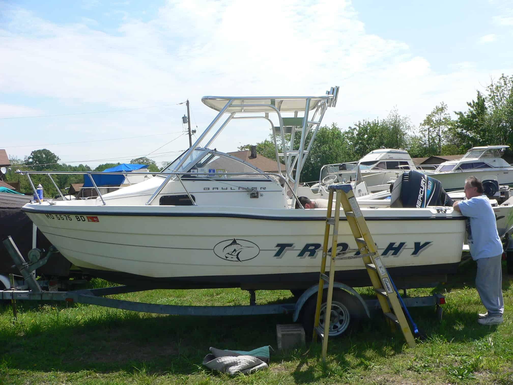 Atlantic Towers Top installed on a Trophy 1802 walkaround boat, with a person working nearby.