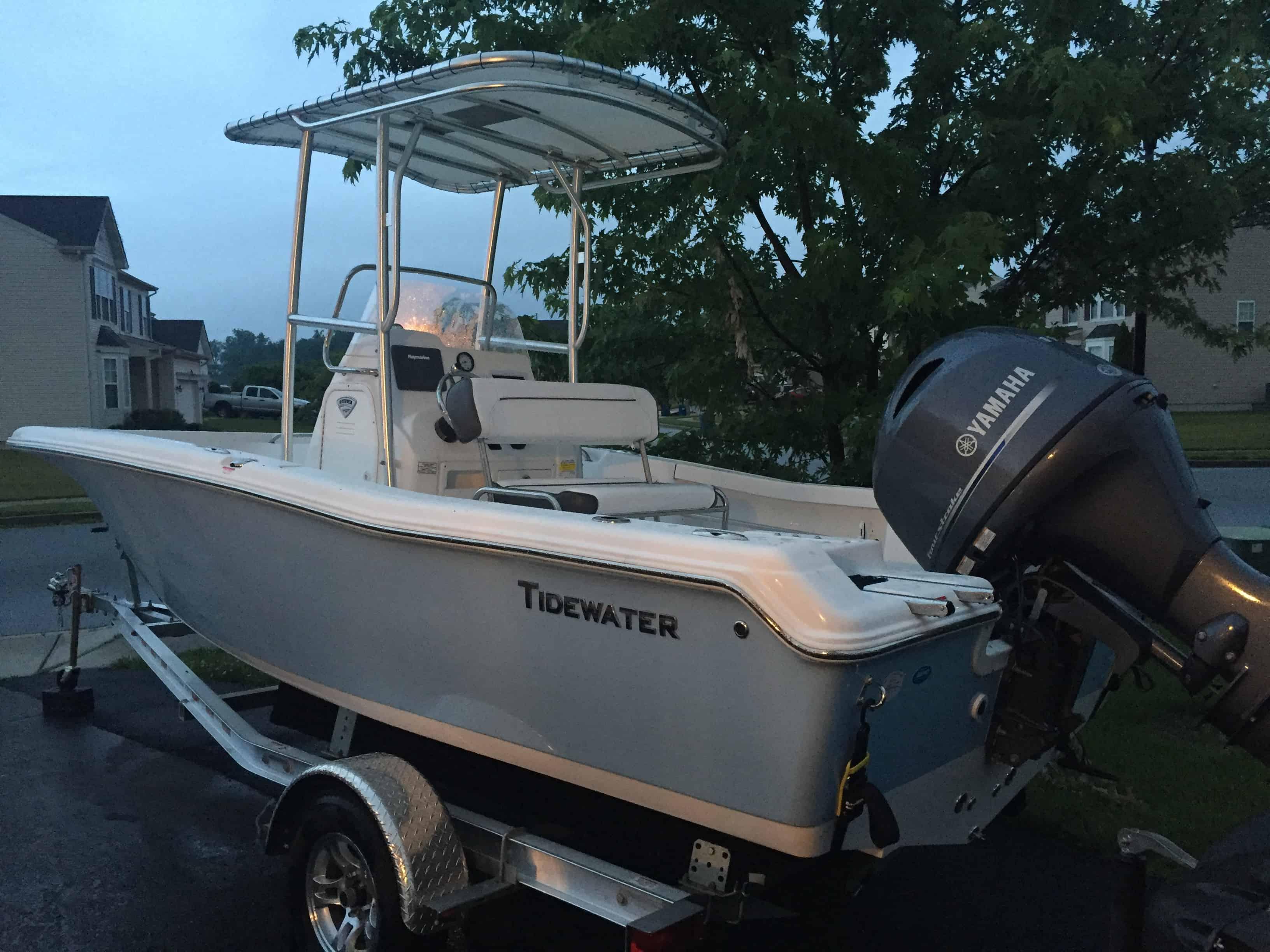 Atlantic Towers T-Top installed on a Tidewater boat parked in a residential area.
