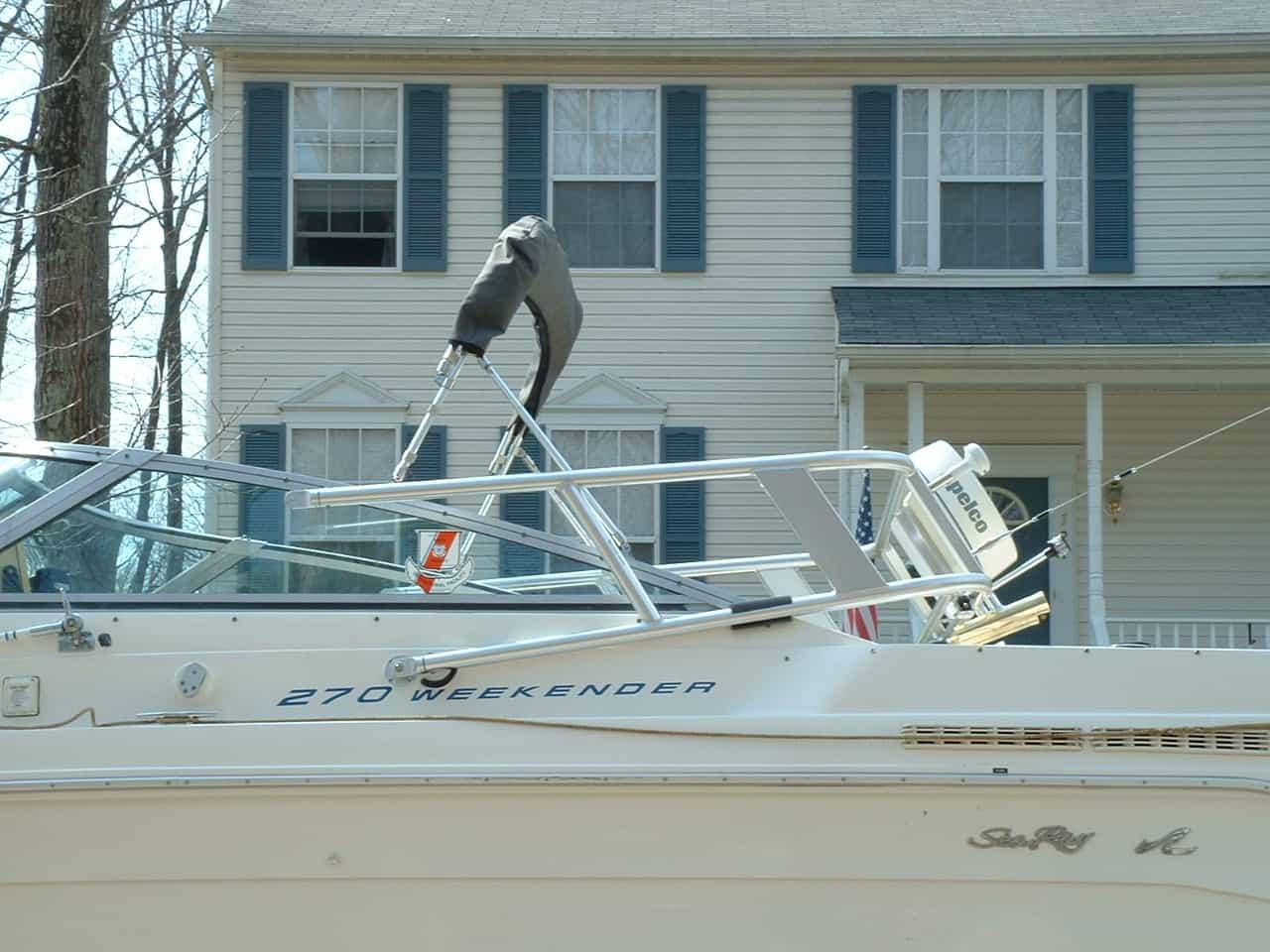 Atlantic Towers arch installed on a Sea Ray 270 Weekender boat parked near a house with blue shutters.