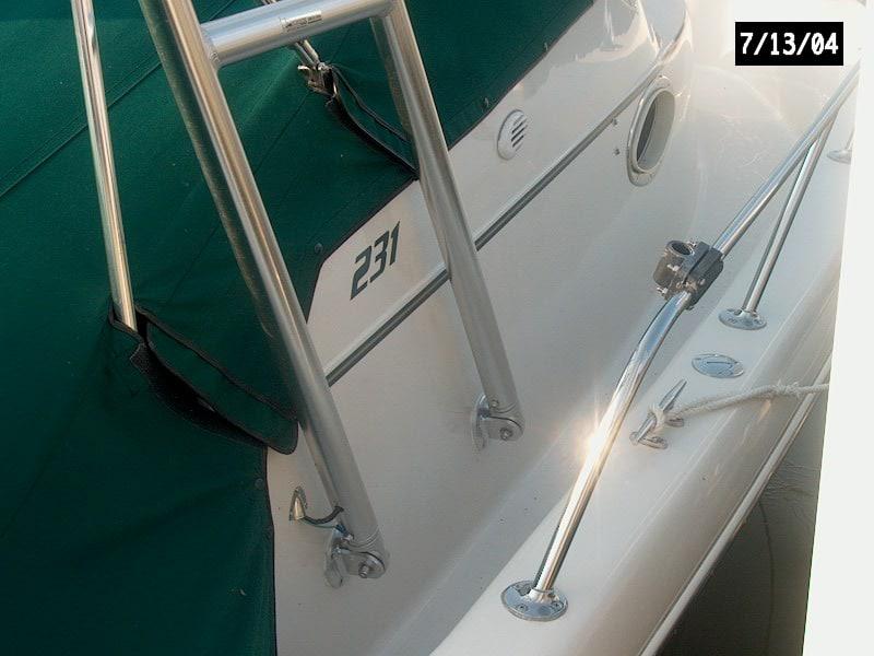 Close-up of Atlantic Towers arch installed on the side of a Pro Line 231 W/A boat with green canvas cover and railing.
