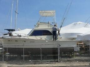 Atlantic Towers Top installed on an Egg Harbor 33 flybridge boat, showing the protective cover and framework.