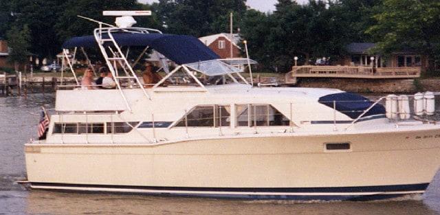 Atlantic Towers arch installed on a Chris Craft 35 Catalina boat, cruising on calm waters with passengers onboard.
