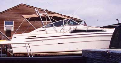 Atlantic Towers Arch installed on a Sea Ray 250 Sundancer boat docked near a building with an air conditioner.
