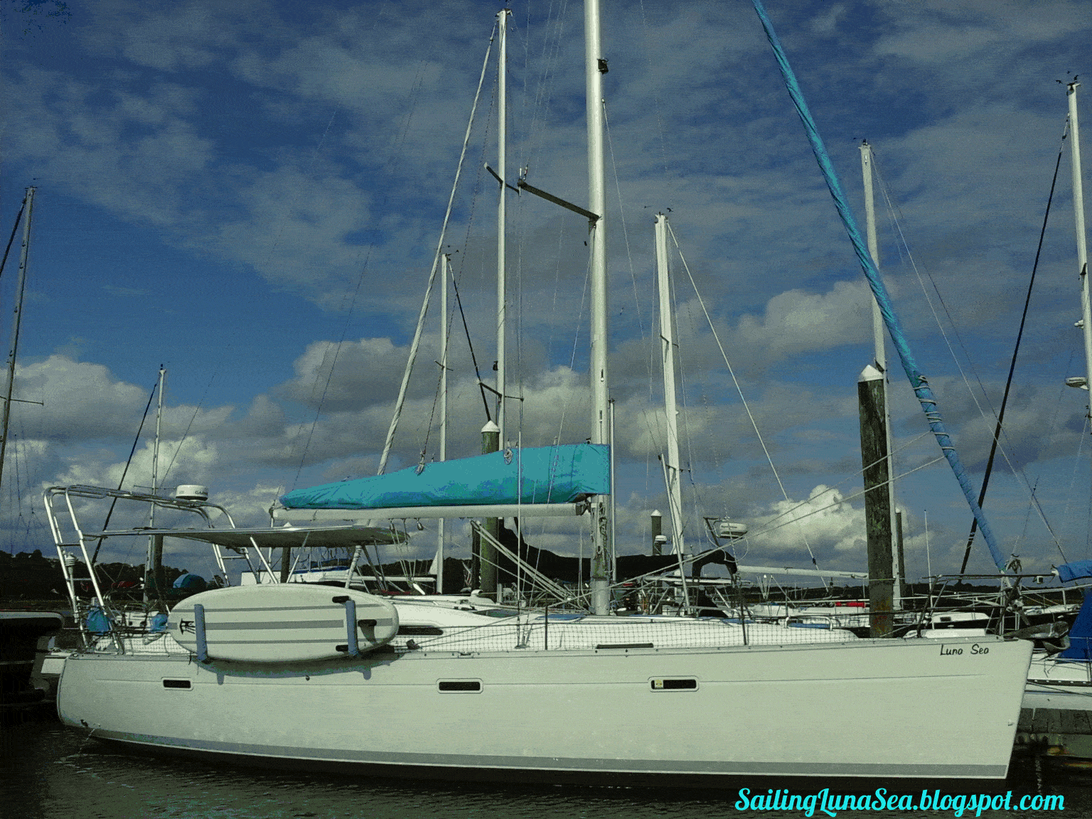 Atlantic Towers Top installed on a Beneteau sailboat docked at the marina under a cloudy sky.