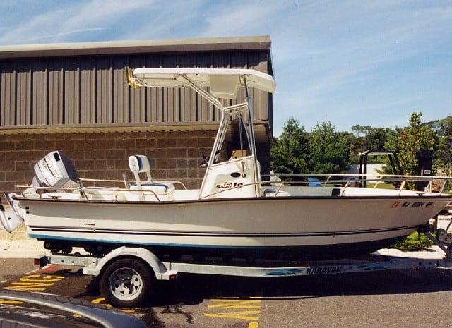 Atlantic Towers T-Top installed on a Triton Center Console boat parked on a trailer outside a building.