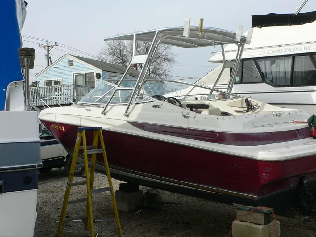 Maxum 2300 SC boat with installed Atlantic Towers Top mounted on the deck, supported by a yellow ladder nearby.