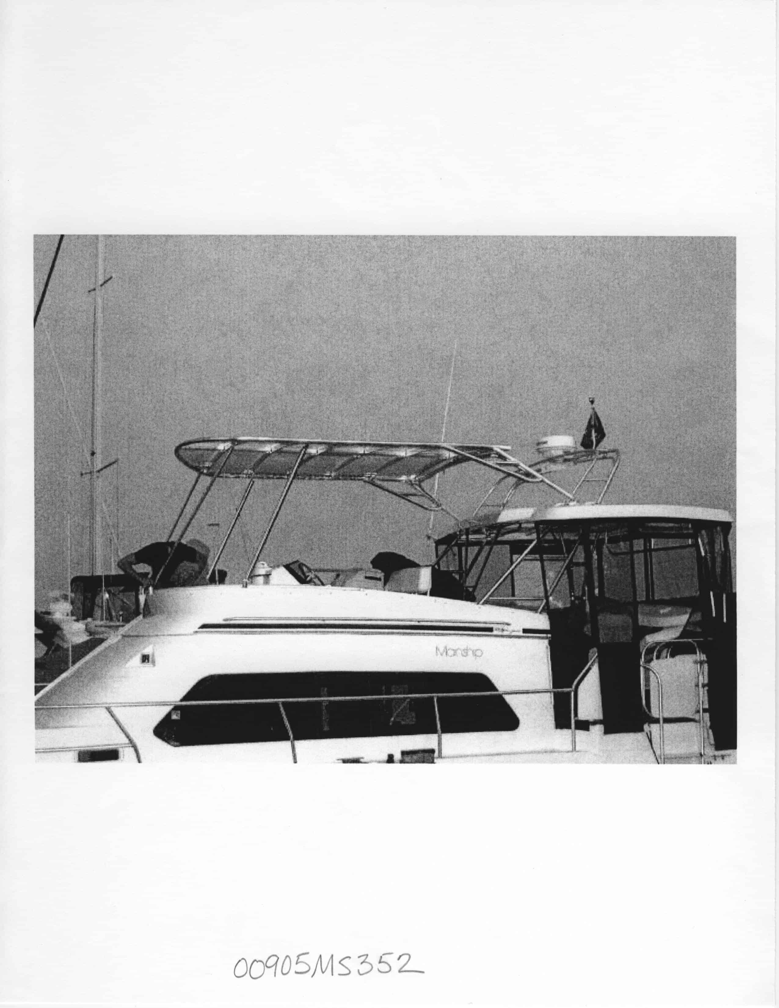 Atlantic Towers Top installed on a Mainship 37 Motor Yacht docked at a marina, showcasing its design and structure.