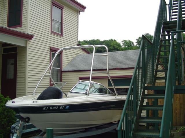 Atlantic Towers Air Tower installed on a Sea Ray 185 BR boat beside a house and staircase.