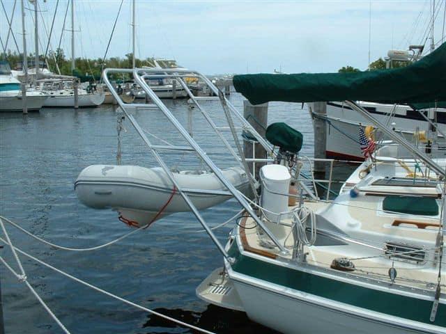 Morgan 41 Out Island sailboat docked at marina with Atlantic Towers Arch installed holding a small dinghy.