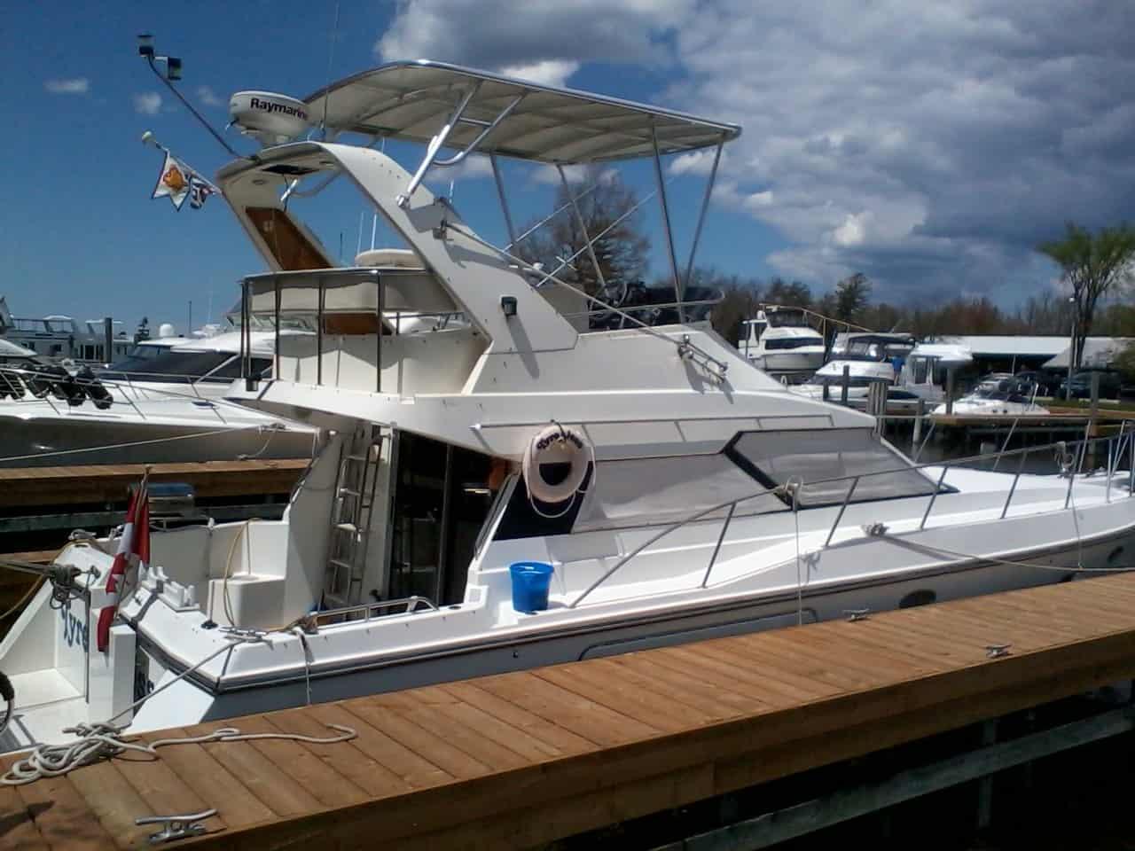 Atlantic Towers Top installed on a Baja boat, docked at a marina with other boats and a cloudy sky.