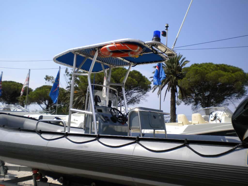 Atlantic Towers T-Top installed on Zodiac 730 RIB boat shown from the rear with folded bimini on a trailer.
