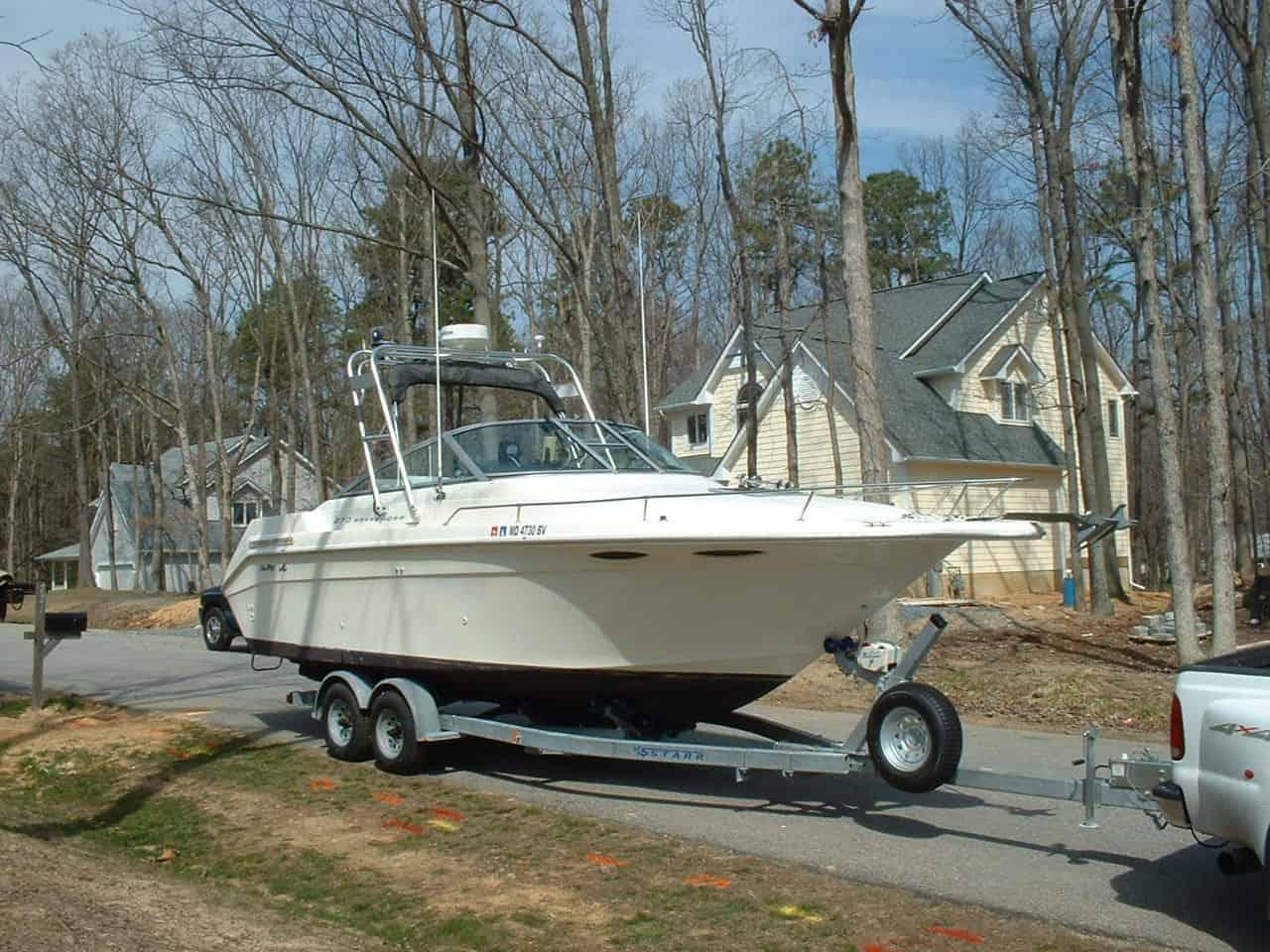 Atlantic Towers Arch installed on a Sea Ray 270 Weekender boat parked on a trailer in a residential area.