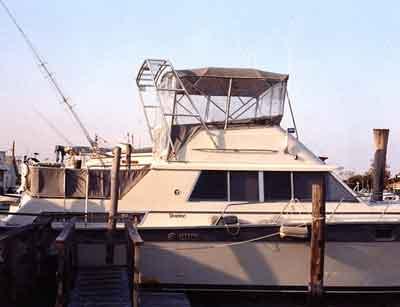 Atlantic Towers Arch installed on a Silverton 40 Aft Cabin boat showing the white tubular frame against a cloudy sky.