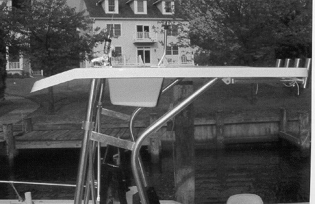 Atlantic Towers T-Top installed on a Sea Ox 20 Console boat with houses and trees in the background by the dock.