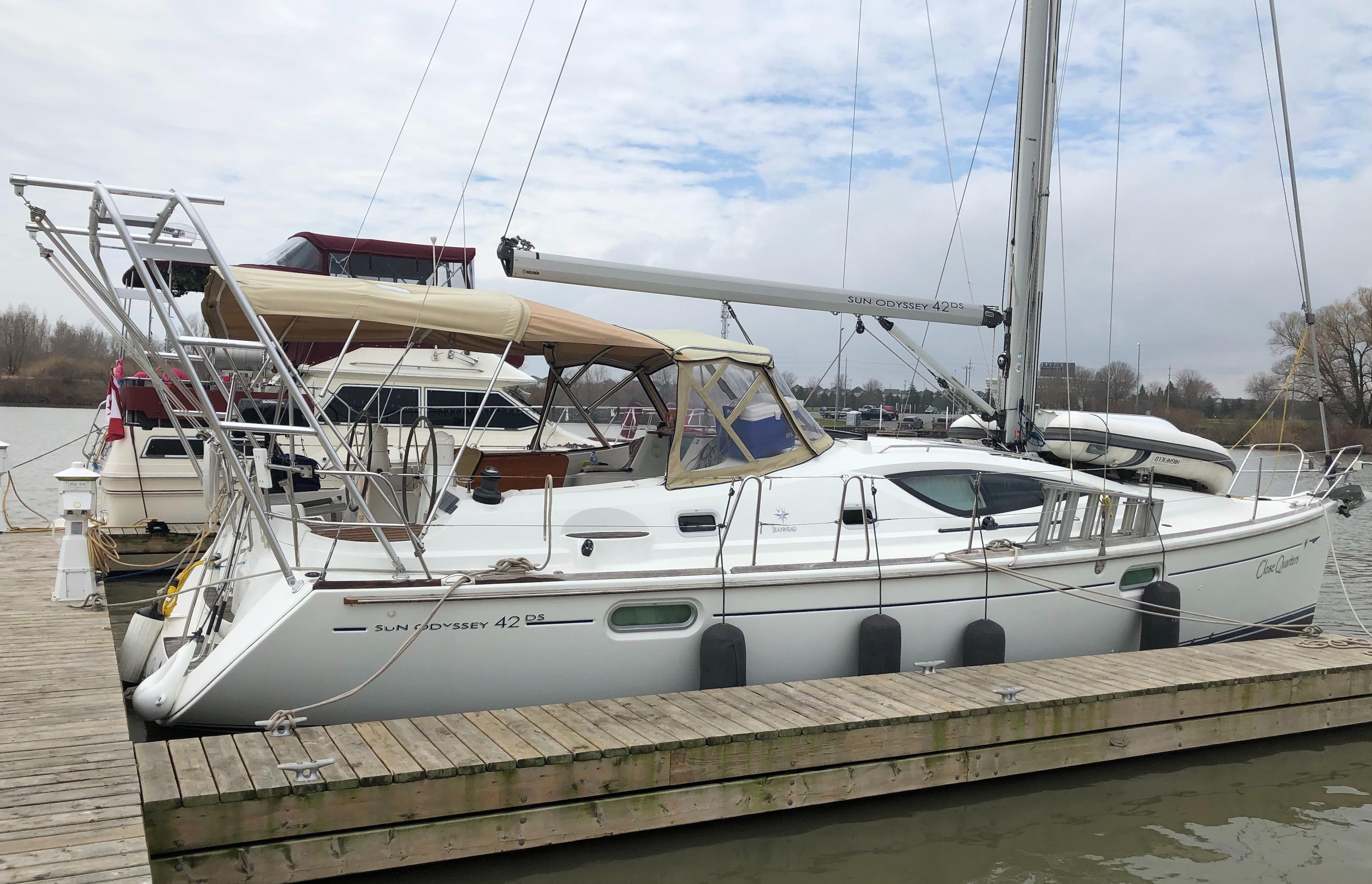 Atlantic Towers Arch installed on a Jeanneau sailboat at the marina, with visible dock and moored boats in the background.