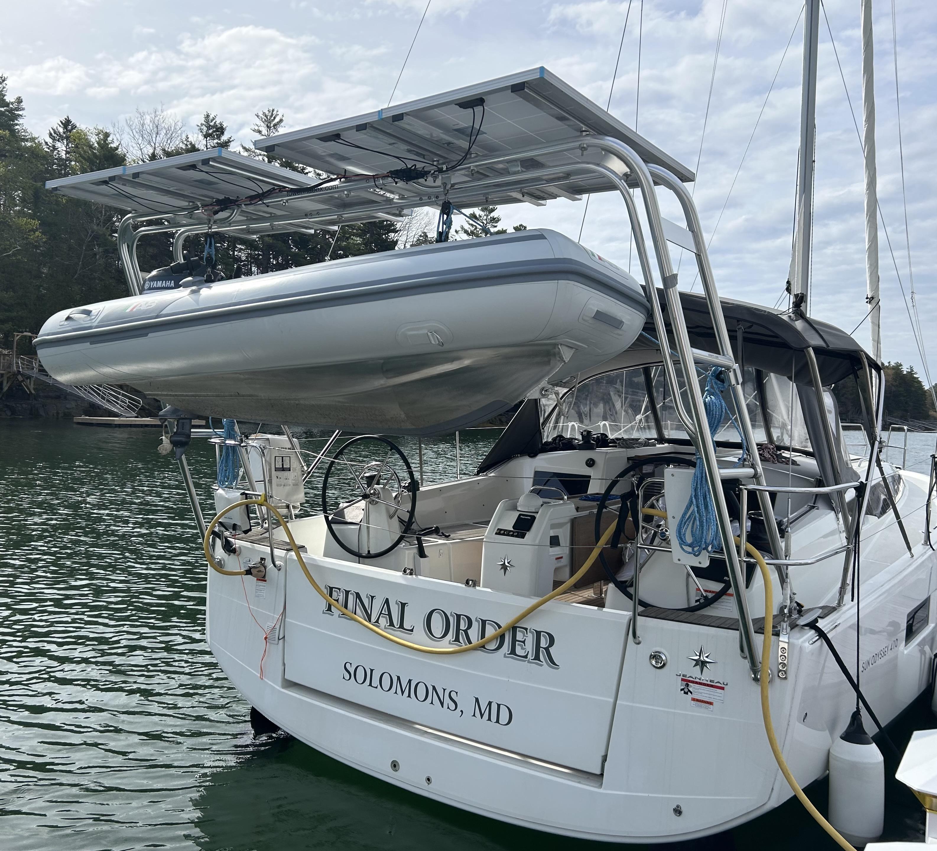 Atlantic Towers Arch mounted on a yacht with a dinghy above, parked in a serene water setting.