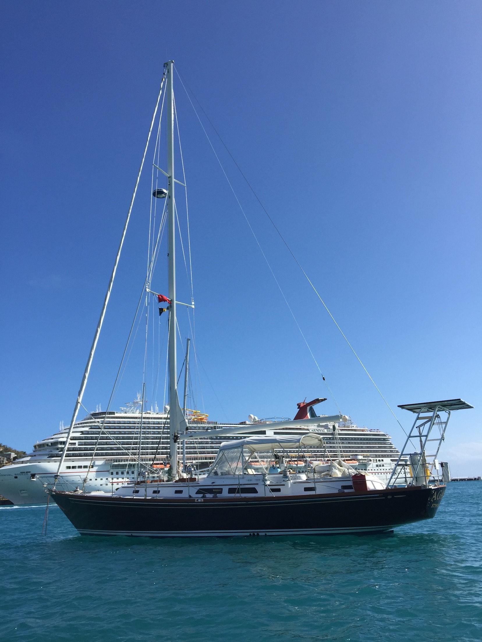 Atlantic Towers Arch installed on an Alden sailboat anchored in clear blue waters with a cruise ship in the background.
