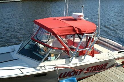 Atlantic Towers Arch installed on a Formula boat with a red canopy and clear windshield, docked by the water.