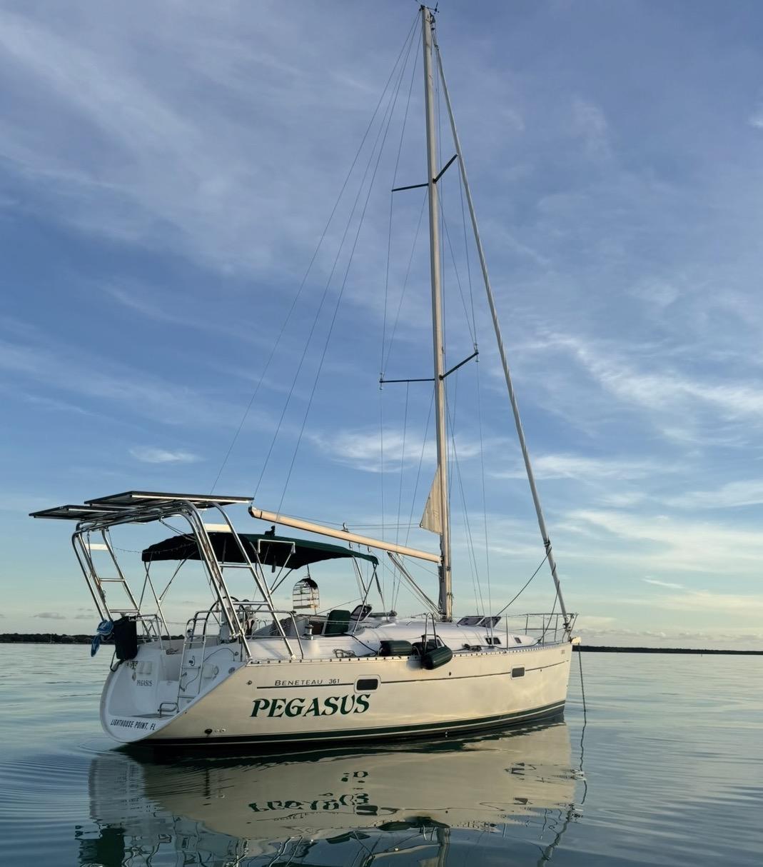 Atlantic Towers Arch installed on a Beneteau sailboat named Pegasus, anchored in calm waters under a blue sky.