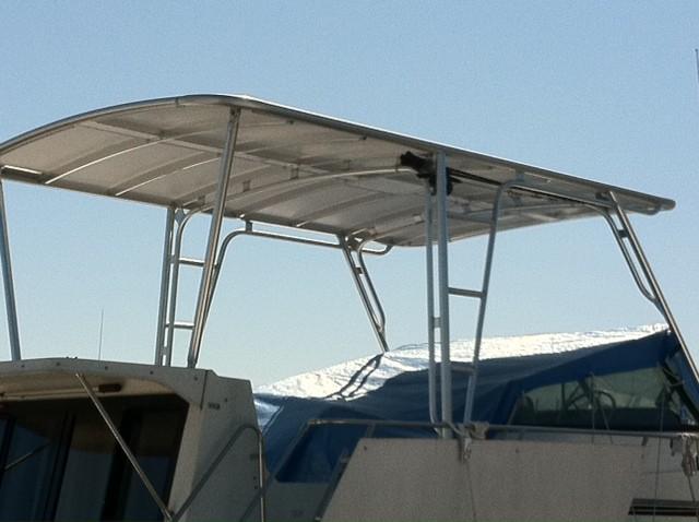 Atlantic Towers T-Top installed on Carver 32/330 Mariner boat with a metal frame and hard roof under clear sky.