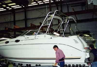 Atlantic Towers Arch installed on a Sea Ray 260 Sundancer boat in a boat maintenance facility.