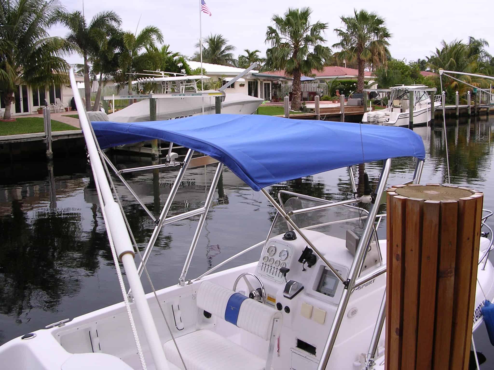Atlantic Towers arch on a Pro Line Sport 19 Console boat, featuring a blue canopy in a marina setting.
