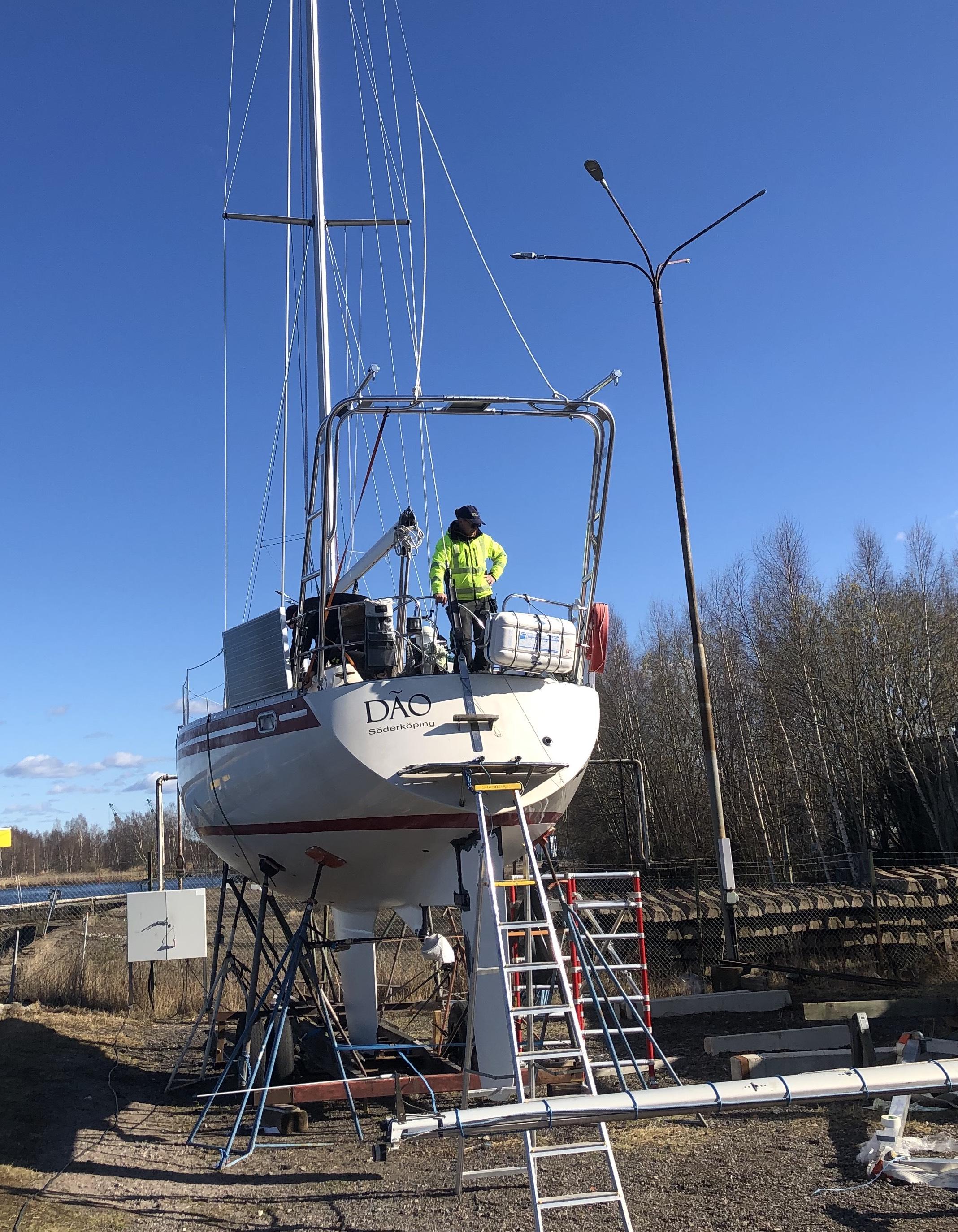 Atlantic Towers Arch installed on a boat, with a person working above and blue sky in the background.