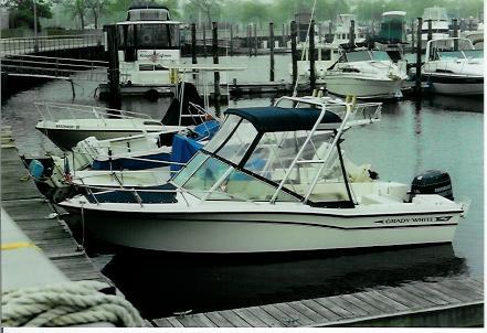 Atlantic Towers Arch installed on a Grady White 19 Tournament boat docked at a marina with other boats nearby.