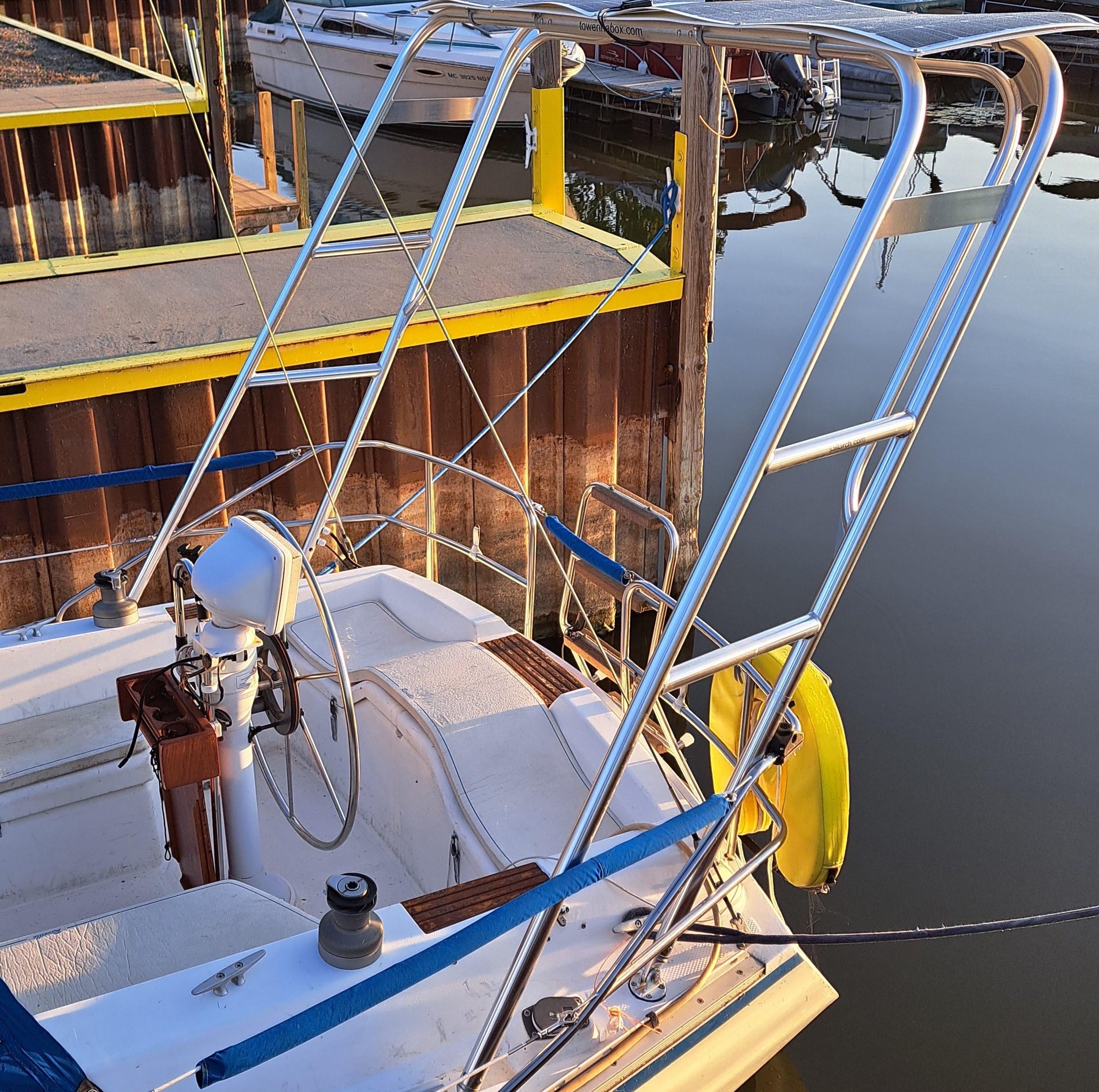 Atlantic Towers Arch installed on a boat, showcasing its polished frame against a marina backdrop.