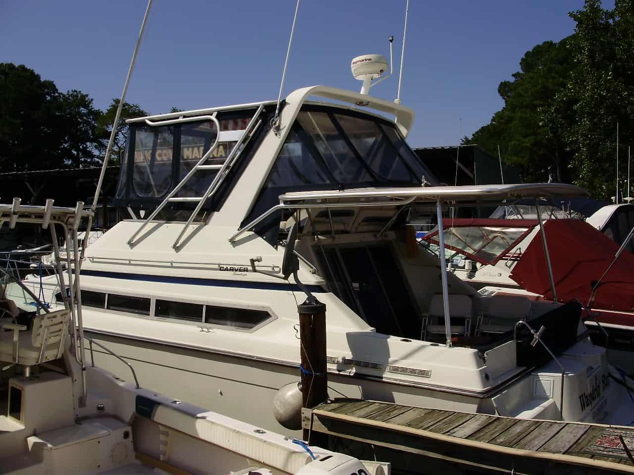 Carver 38 Santego boat docked with Atlantic Towers Top installed on the cabin roof under a clear sky.