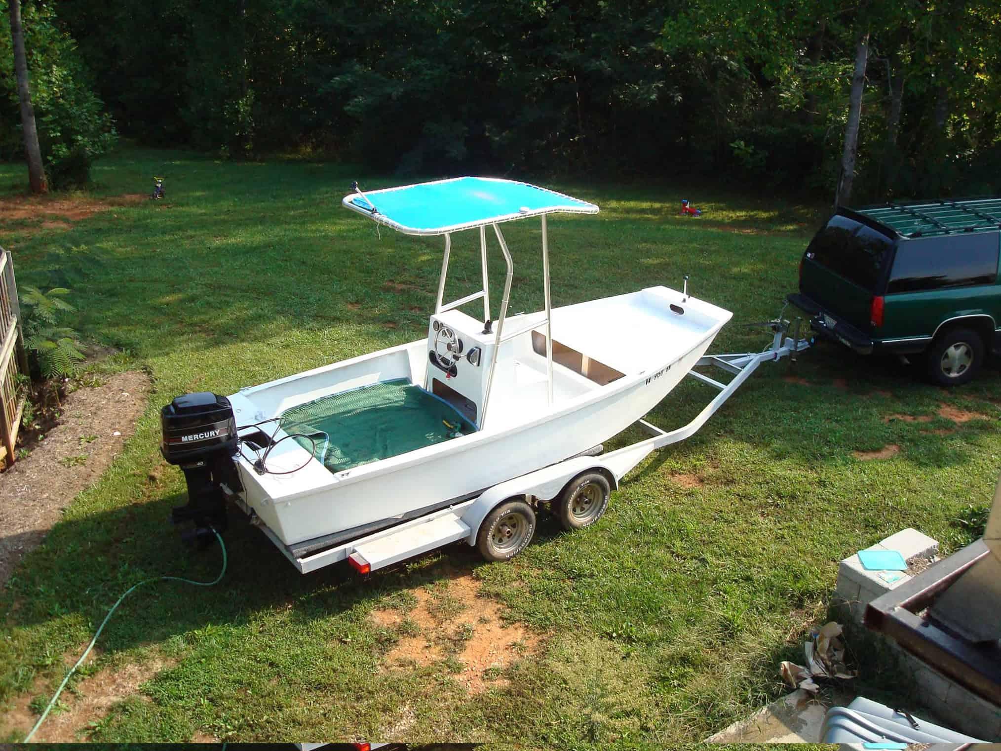 Atlantic Towers T-Top installed on a custom Jon Boat, parked on a grassy area next to a vehicle.