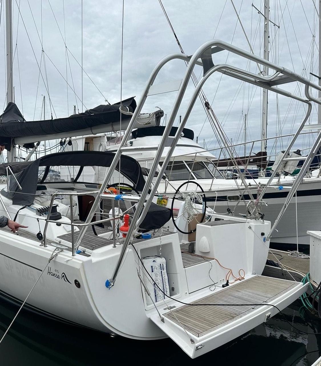 Hanse sailboat docked with Atlantic Towers Arch installed at the stern, featuring a lowered swim platform and rigging.