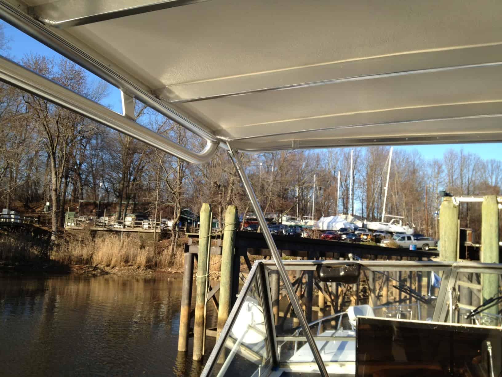 Atlantic Towers view from a boat with a canopy, showcasing a marina and wooden docks in the background.