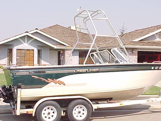 Atlantic Towers Air Tower installed on a Crestliner 1950 boat, parked on a trailer in a residential area.