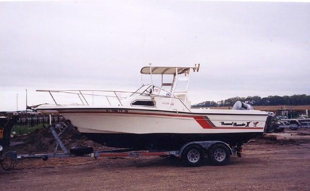 Atlantic Towers Top installed on a Celebrity 210 Fish Hawk boat, parked on a trailer in a marina area.
