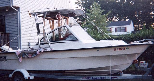 Atlantic Towers Top installed on a Maritime Skiff boat parked on a trailer near a residential area.