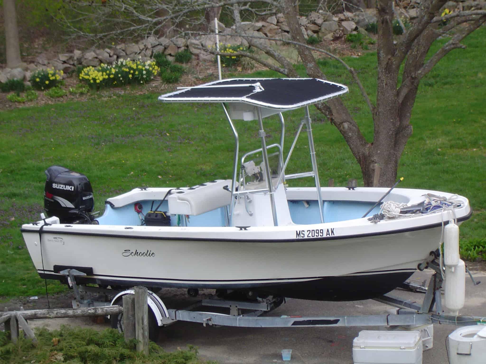 Atlantic Towers T-Top installed on an Ocean Scout 20 center console boat, parked on a trailer in a grassy area.