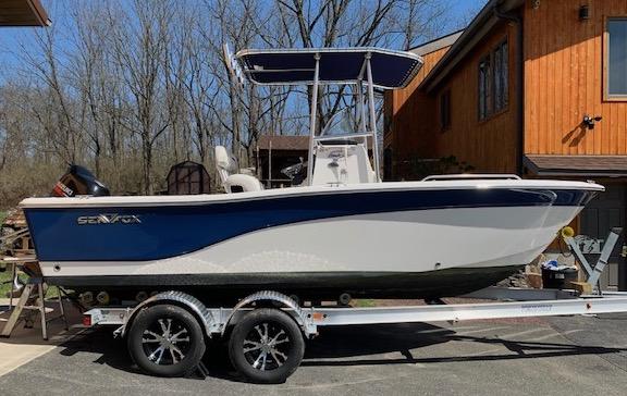 Atlantic Towers T-Top installed on a Sea Fox boat, parked on a trailer outside a wood building.