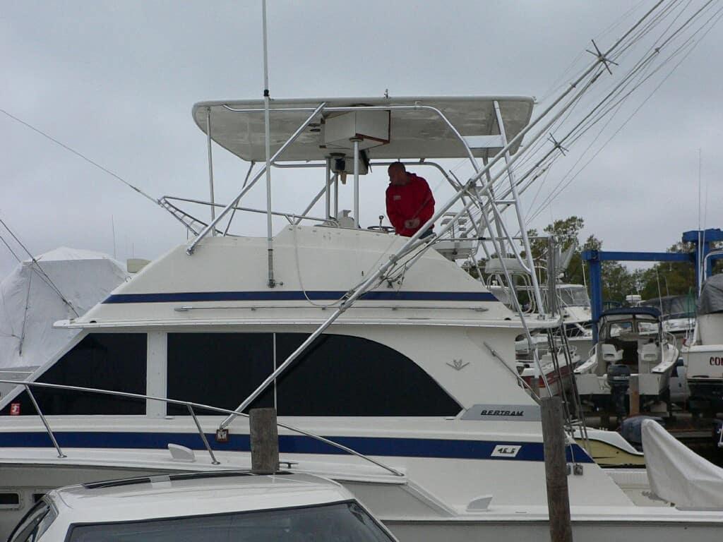 Atlantic Towers Top installed on a Bertram 46 Convertible with a man standing on the upper deck in a marina.