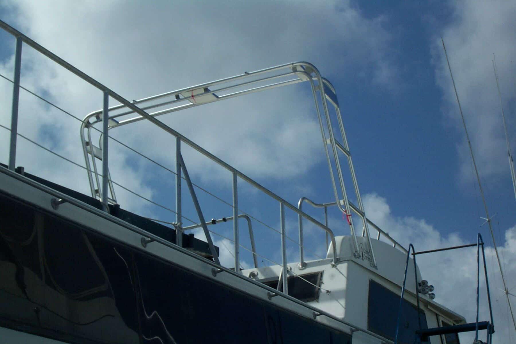 Atlantic Towers Arch installed on a Carrie Craft 60 House Boat, with a backdrop of blue sky and clouds.