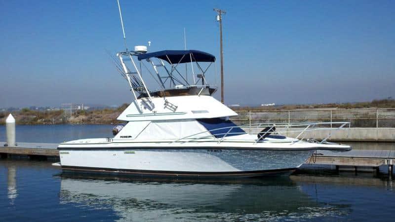 Atlantic Towers T-Top installed on a white boat docked at a marina under a clear blue sky.