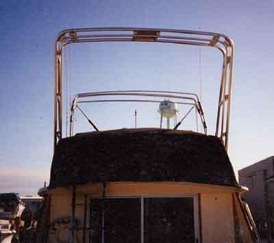 Atlantic Towers Arch installed on the upper deck of a Silverton 34 Convertible boat at sunset.