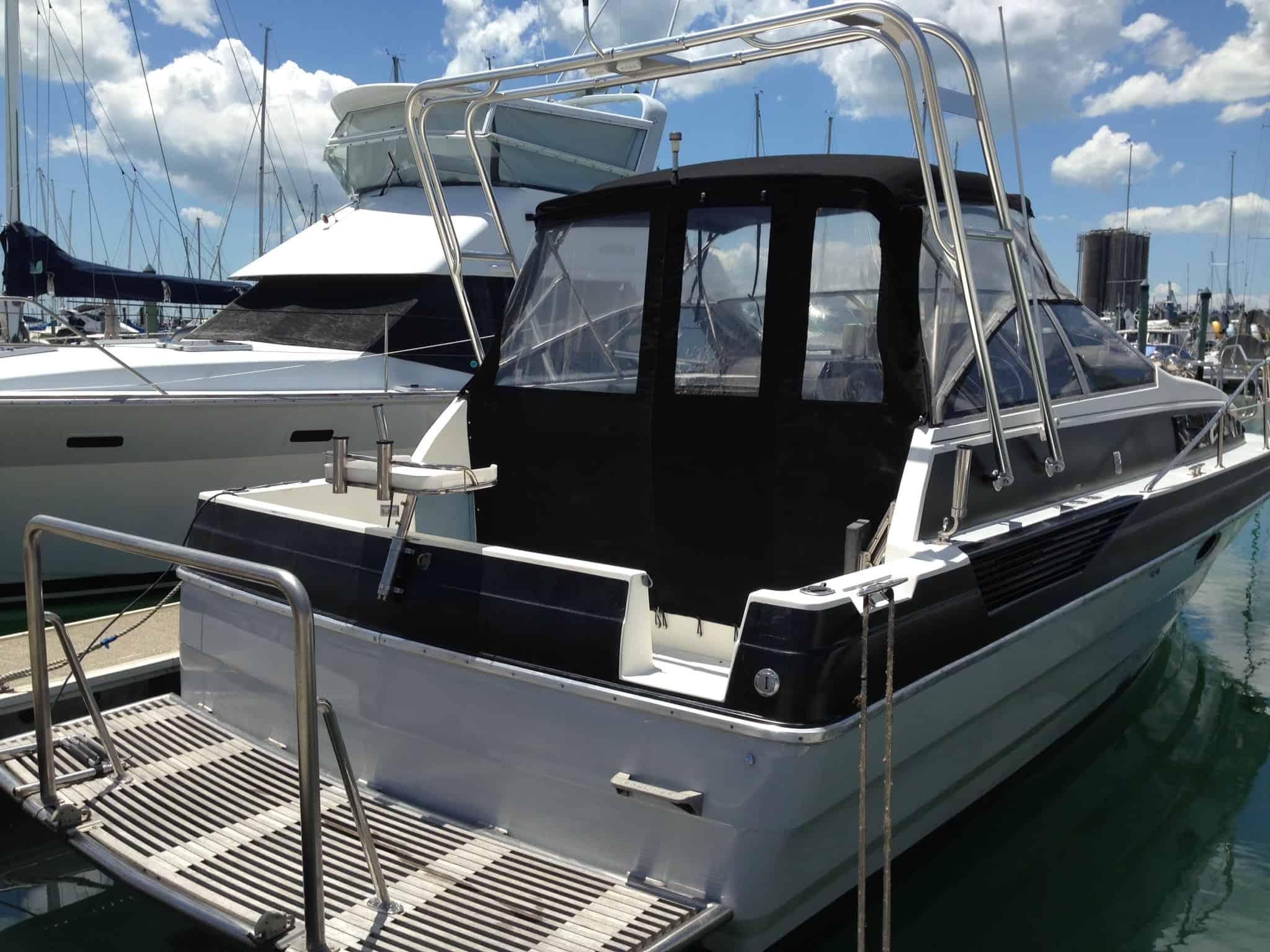 Atlantic Towers boat docked at a marina, showcasing its sleek design and multiple windows with a clear sky in the background.