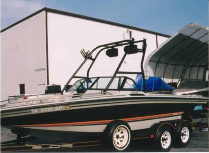 Atlantic Towers Air Tower installed on a Supra boat, parked in front of a building with a covered area.