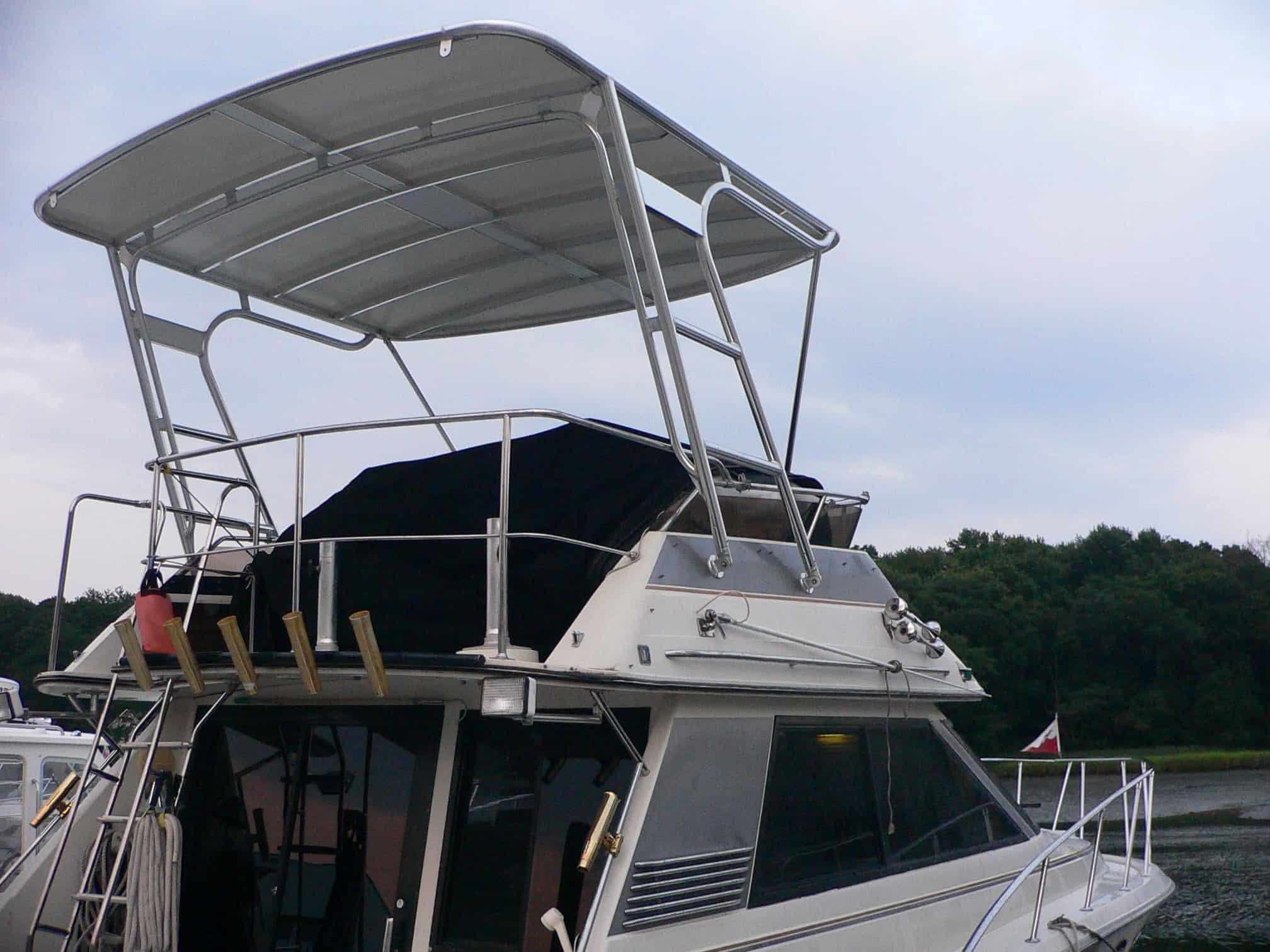 Atlantic Towers Top installed on the upper deck of a Wellcraft 3700 Cozumel boat with railings and a covered seating area.