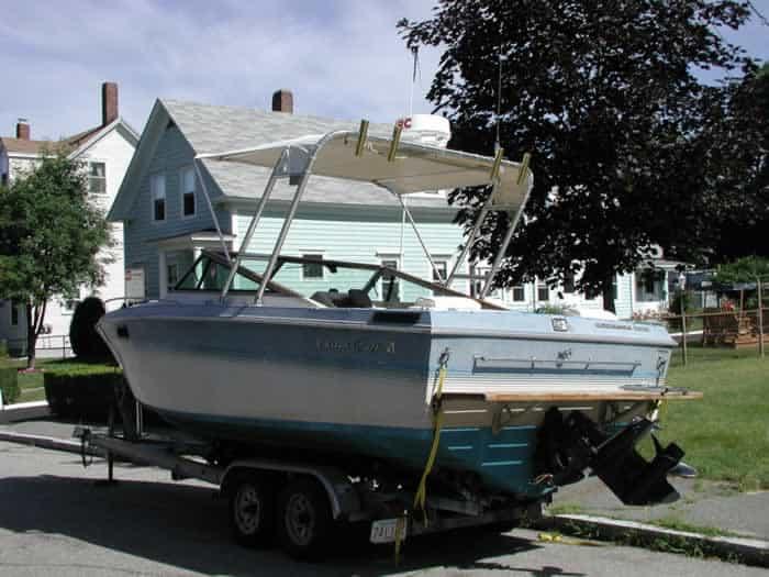 Atlantic Towers Top installed on a Chris Craft Scorpian boat, parked on a trailer near residential homes.
