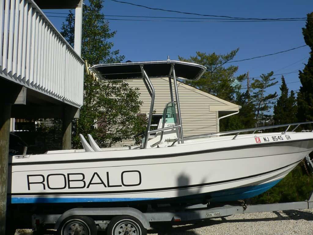 Atlantic Towers T-Top installed on a Robalo 2120 center console boat docked at a marina with calm water.
